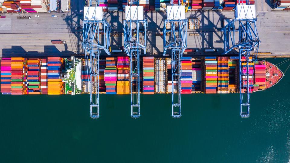 Container cargo ship at industrial port in import export business logistic and transportation of international by container cargo ship in the open sea.